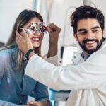 Optometrist checking patient eyesight and vision correction